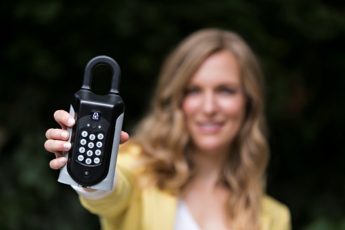 A real estate agent holding a sentriguard key safe