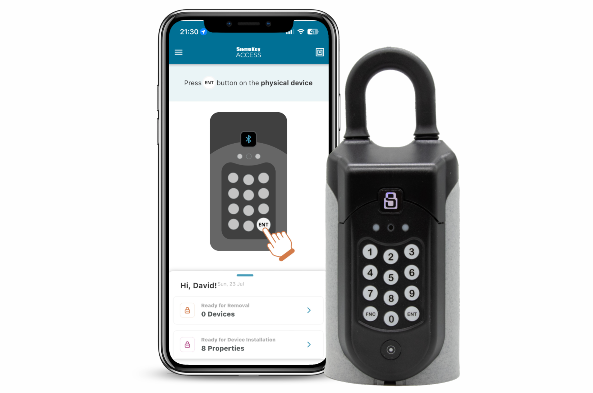 A sentriguard key safe next to a mobile phone with the key access app on screen