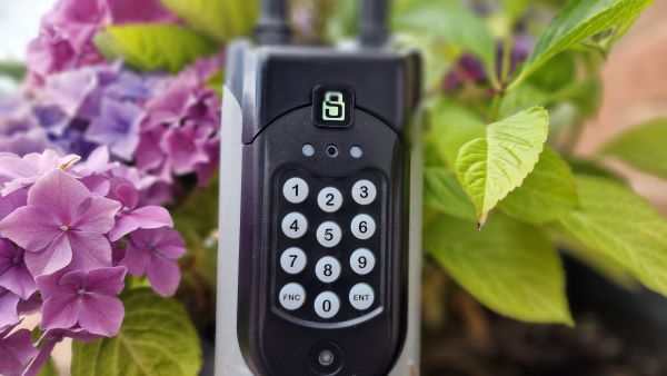Keynetics SentriGuard key safe close up shot with flowers and leaves in the background
