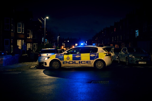Police car parked in a residential area at night