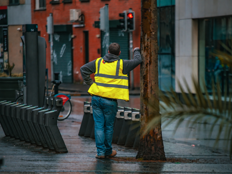 A contractor standing in the street waiting for a keyholder